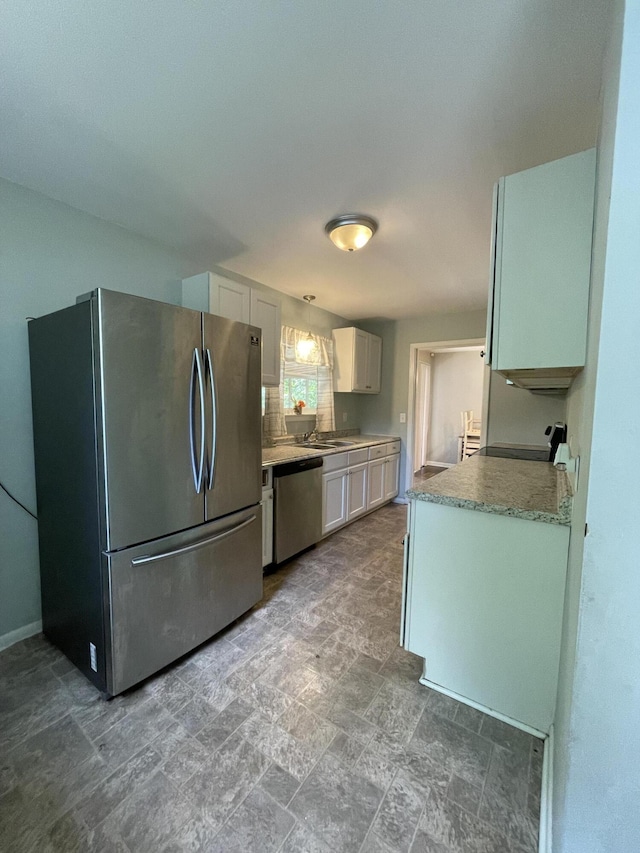 4702 Eldridge Rd, Hixson, TN 37343 - kitchen with appliances with stainless steel finishes, white cabinetry, light countertops, and stone finish flooring