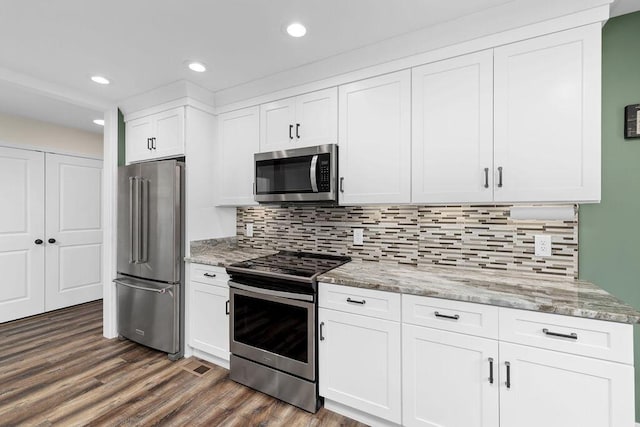 6859 Steep Hl, Ooltewah, TN 37363 - kitchen with appliances with stainless steel finishes, white cabinets, light stone counters, dark wood-type flooring, and recessed lighting