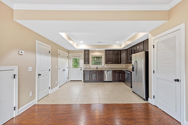 1864 Gate Tower Way NE, Cleveland, TN 37312 - kitchen with appliances with stainless steel finishes, dark brown cabinets, light tile patterned floors, crown molding, and a tray ceiling