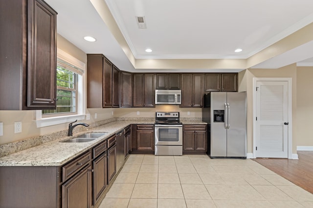 1864 Gate Tower Way NE, Cleveland, TN 37312 - kitchen featuring appliances with stainless steel finishes, dark brown cabinets, ornamental molding, light stone countertops, and recessed lighting