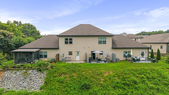 1864 Gate Tower Way NE, Cleveland, TN 37312 - rear view of house featuring a patio, a sunroom, a lawn, and a shingled roof