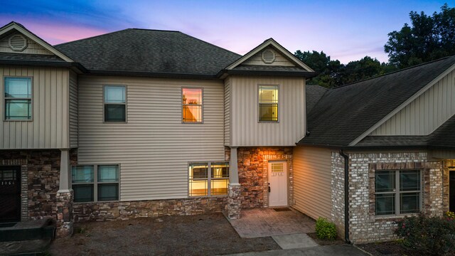 1864 Gate Tower Way NE, Cleveland, TN 37312 - view of front of house with stone siding, a shingled roof, and board and batten siding