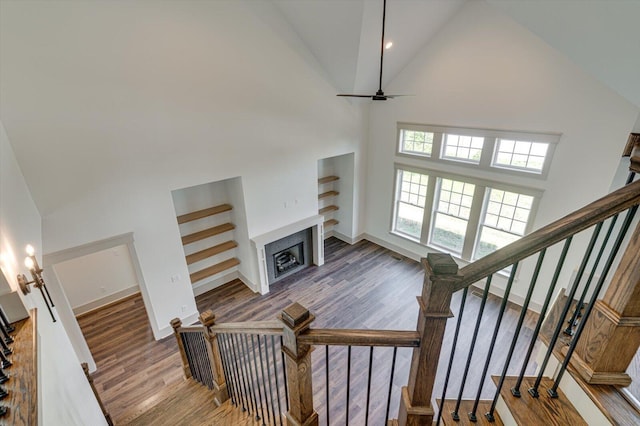 7104 Paxton Cir, Hixson, TN 37343 - stairs with high vaulted ceiling, wood finished floors, a fireplace, a ceiling fan, and recessed lighting