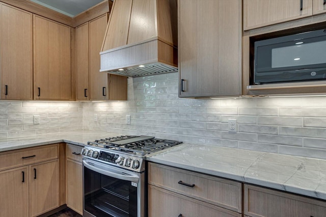 7104 Paxton Cir, Hixson, TN 37343 - kitchen with stainless steel gas range oven, premium range hood, black microwave, and backsplash