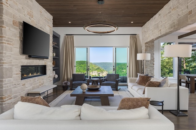 1034 Montlake Rd, Soddy Daisy, TN 37379 - living room featuring wooden ceiling, wood finished floors, a stone fireplace, healthy amount of natural light, and built in features