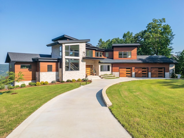 1034 Montlake Rd, Soddy Daisy, TN 37379 - modern home with stone siding, a front yard, concrete driveway, and an attached garage
