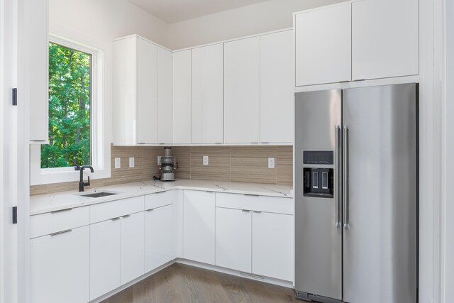 1034 Montlake Rd, Soddy Daisy, TN 37379 - kitchen featuring high end refrigerator, light stone countertops, backsplash, white cabinetry, and wood finished floors