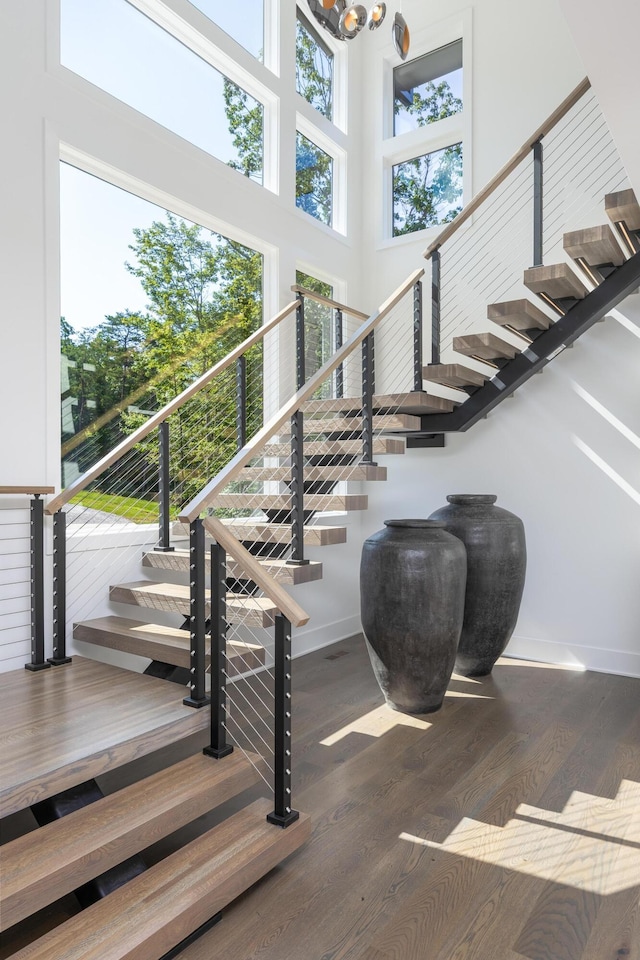 1034 Montlake Rd, Soddy Daisy, TN 37379 - stairway with wood finished floors, a high ceiling, and a chandelier