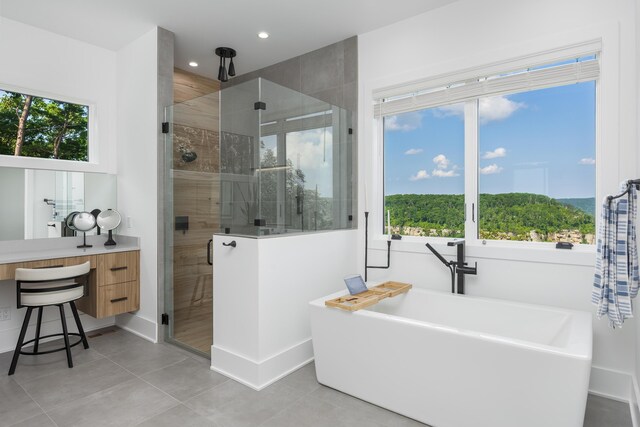 1034 Montlake Rd, Soddy Daisy, TN 37379 - bathroom with a shower stall, a freestanding tub, tile patterned flooring, recessed lighting, and vanity