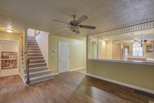 9028 Warbler Ln, Chattanooga, TN 37421 - unfurnished living room with a textured ceiling, wood finished floors, stairs, and ceiling fan