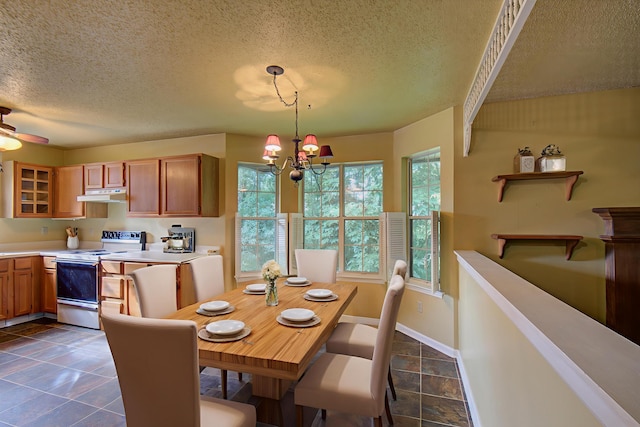 9028 Warbler Ln, Chattanooga, TN 37421 - dining room with a textured ceiling, a chandelier, and stone tile flooring