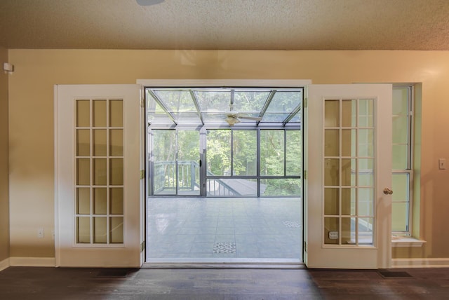 9028 Warbler Ln, Chattanooga, TN 37421 - doorway featuring dark wood-style flooring, a sunroom, and a textured ceiling