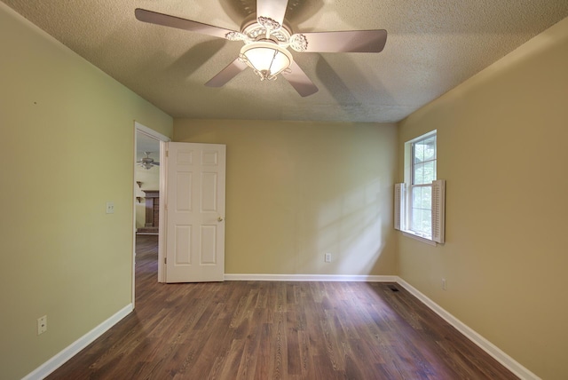 9028 Warbler Ln, Chattanooga, TN 37421 - unfurnished room featuring a textured ceiling, dark wood finished floors, and a ceiling fan