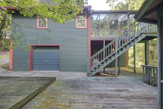 9028 Warbler Ln, Chattanooga, TN 37421 - rear view of house featuring a deck, stairway, a sunroom, and a garage