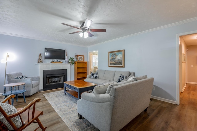 171 Gentry Rd, Ringgold, GA 30736 - living area featuring ceiling fan, wood finished floors, a fireplace with flush hearth, ornamental molding, and a textured ceiling