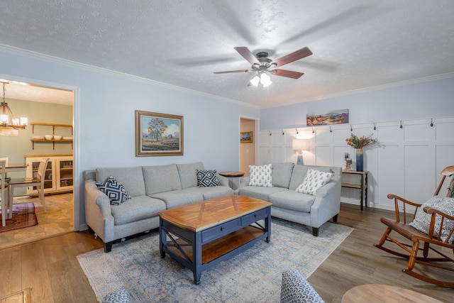 171 Gentry Rd, Ringgold, GA 30736 - living room featuring a chandelier, wood finished floors, a ceiling fan, a textured ceiling, and ornamental molding