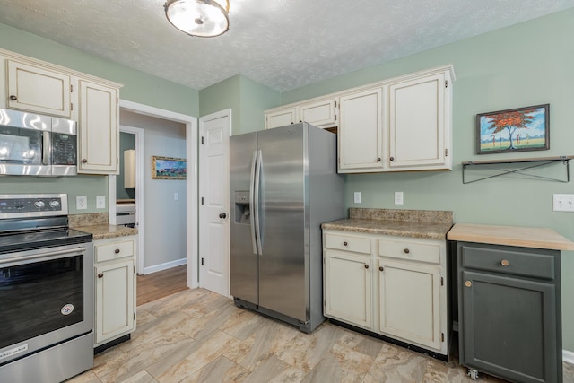 171 Gentry Rd, Ringgold, GA 30736 - kitchen with stainless steel appliances, a textured ceiling, and light countertops