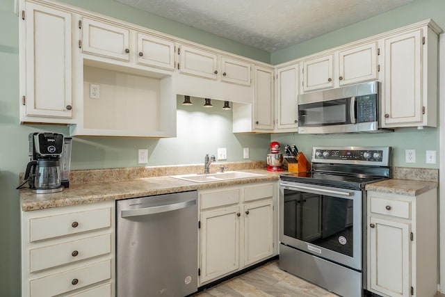 171 Gentry Rd, Ringgold, GA 30736 - kitchen with stainless steel appliances, light countertops, a textured ceiling, and light wood-type flooring