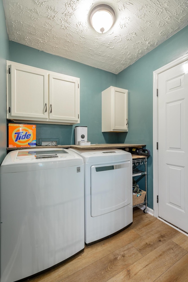 171 Gentry Rd, Ringgold, GA 30736 - laundry area featuring cabinet space, washing machine and dryer, and light wood-style floors