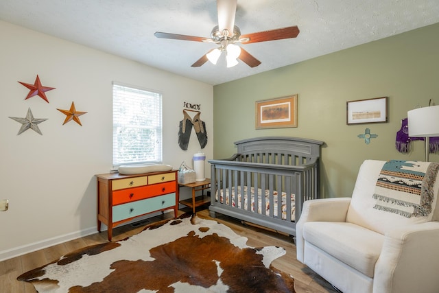 171 Gentry Rd, Ringgold, GA 30736 - bedroom featuring wood finished floors, a nursery area, and a ceiling fan