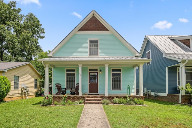509 E 16th St, Chattanooga, TN 37408 - view of front facade featuring a standing seam roof, a porch, a front yard, and a metal roof