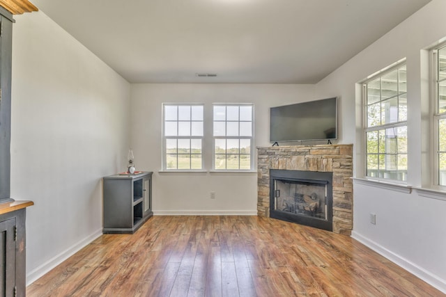 4976 Stewart Rd, Tunnel Hill, GA 30755 - unfurnished living room with hardwood / wood-style flooring and a stone fireplace