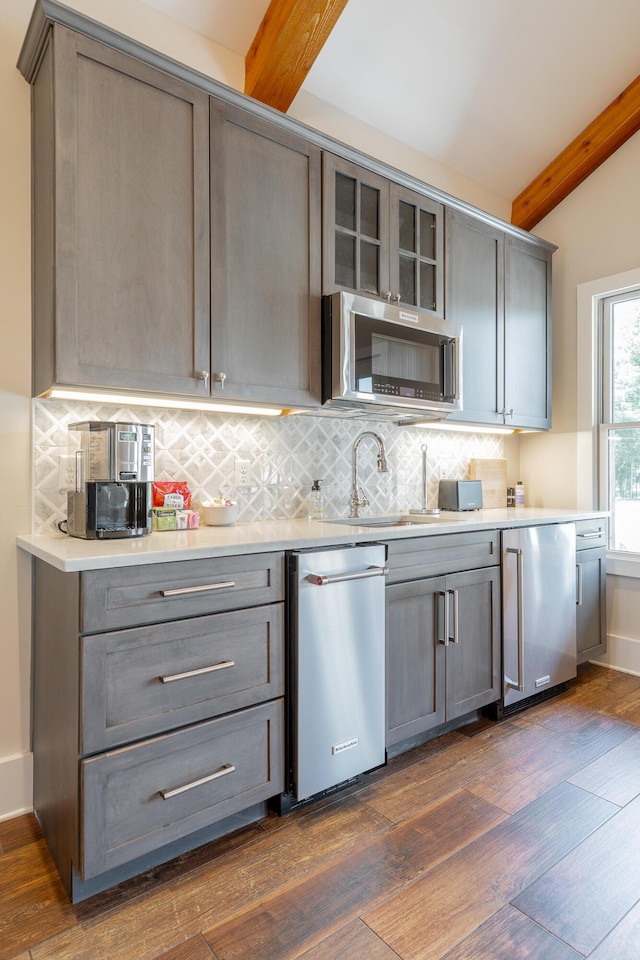 8 Heather Ln, Rising Fawn, GA 30738 - kitchen featuring beam ceiling, stainless steel appliances, gray cabinetry, and decorative backsplash
