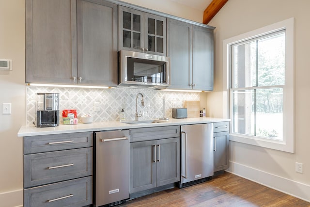 8 Heather Ln, Rising Fawn, GA 30738 - kitchen featuring stainless steel microwave, refrigerator, gray cabinets, decorative backsplash, and beam ceiling