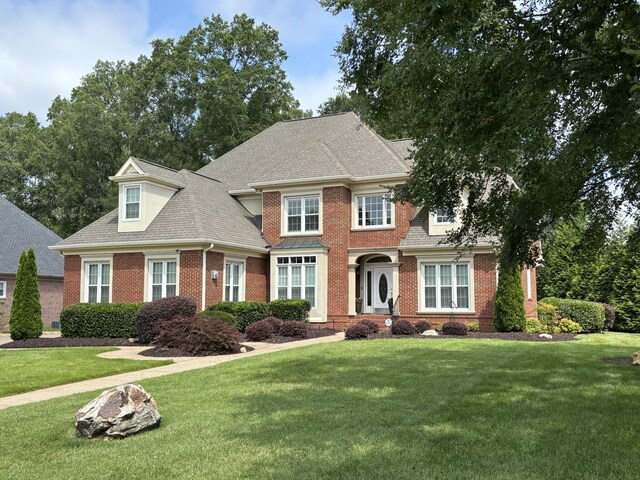 6419 Camdendown Ln, Hixson, TN 37343 - view of front facade with brick siding, a front yard, and a shingled roof