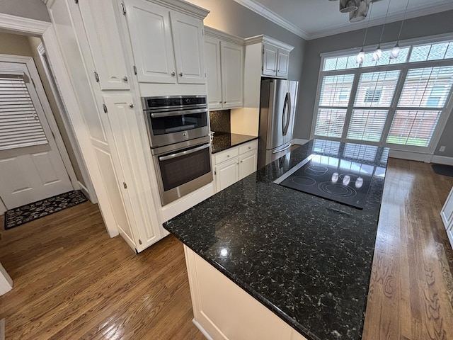6419 Camdendown Ln, Hixson, TN 37343 - kitchen with stainless steel appliances, dark wood-style flooring, crown molding, white cabinetry, and dark stone counters
