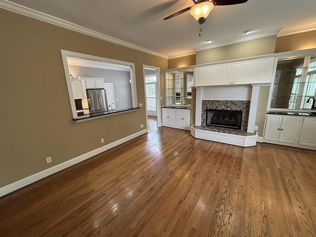6419 Camdendown Ln, Hixson, TN 37343 - unfurnished living room with a ceiling fan, crown molding, dark wood-style flooring, and a fireplace