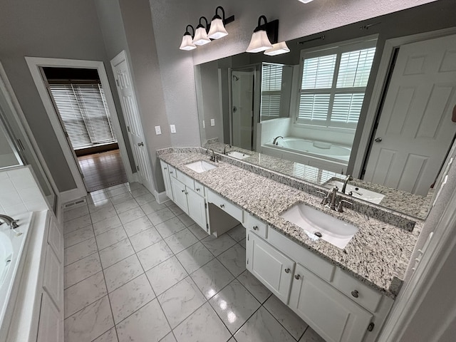 6419 Camdendown Ln, Hixson, TN 37343 - full bathroom featuring a bath, a stall shower, marble look tiles, and double vanity