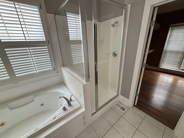 6419 Camdendown Ln, Hixson, TN 37343 - bathroom featuring a shower stall, a jetted tub, and tile patterned floors