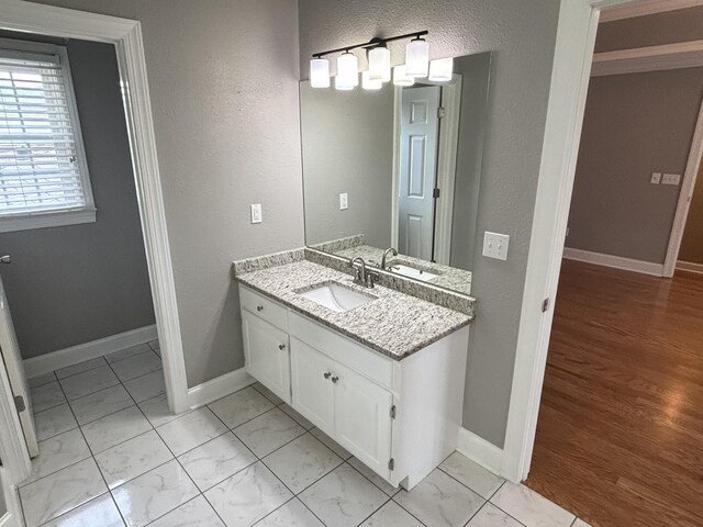 6419 Camdendown Ln, Hixson, TN 37343 - bathroom featuring marble finish floors, vanity, and a textured wall