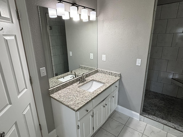 6419 Camdendown Ln, Hixson, TN 37343 - full bathroom featuring marble finish floors, vanity, a tile shower, and a textured wall