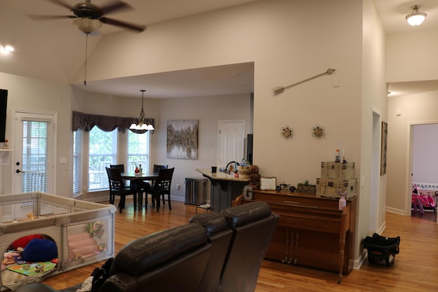 7354 Kayla Beth Ct, Ooltewah, TN 37363 - living room with ceiling fan, high vaulted ceiling, light wood finished floors, and a chandelier