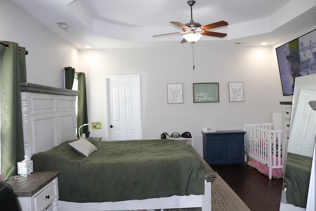 7354 Kayla Beth Ct, Ooltewah, TN 37363 - bedroom with dark wood-style floors, a tray ceiling, a ceiling fan, and recessed lighting