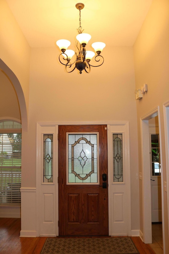 7354 Kayla Beth Ct, Ooltewah, TN 37363 - foyer entrance featuring a chandelier, wood finished floors, arched walkways, and a high ceiling