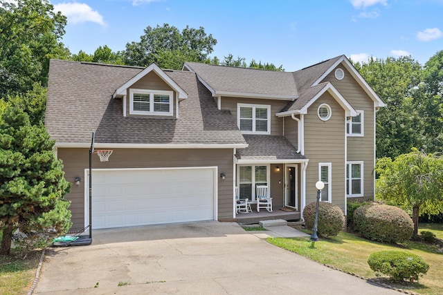 8014 Woodstone Dr, Hixson, TN 37343 - traditional home with a porch, driveway, roof with shingles, and an attached garage