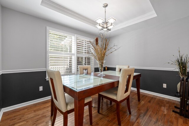 8014 Woodstone Dr, Hixson, TN 37343 - dining area featuring a chandelier, crown molding, wood finished floors, and a tray ceiling