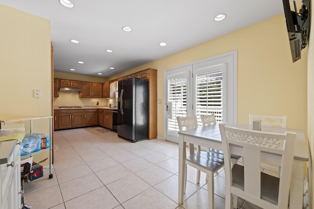 8014 Woodstone Dr, Hixson, TN 37343 - kitchen featuring black fridge, cooktop, brown cabinets, light tile patterned floors, and recessed lighting