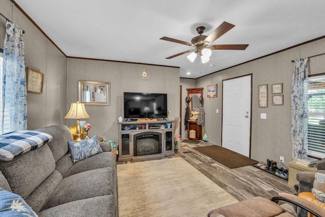 1165 Hugh Allison, Pikeville, TN 37367 - living room featuring wood finished floors, ornamental molding, a ceiling fan, and a glass covered fireplace
