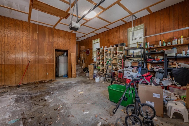 200 Whippoorwill Ln, Lafayette, GA 30728 - garage featuring a garage door opener, wooden walls, and freestanding refrigerator