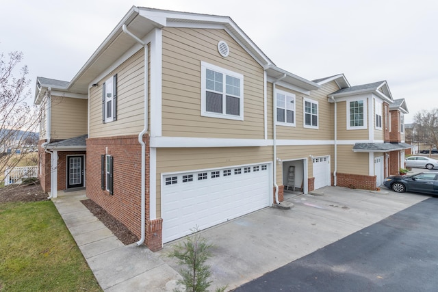 3102 Regency Ct, Chattanooga, TN 37421 - view of front of property featuring a garage, brick siding, and driveway