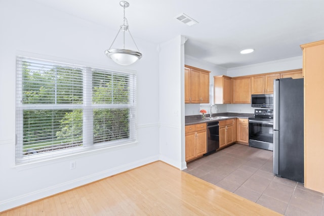 3102 Regency Ct, Chattanooga, TN 37421 - kitchen featuring appliances with stainless steel finishes, dark countertops, pendant lighting, wood finished floors, and ornamental molding