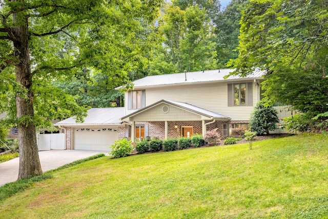 1920 Campbell Dr NW, Cleveland, TN 37312 - view of front of house featuring an attached garage, concrete driveway, brick siding, and a metal roof