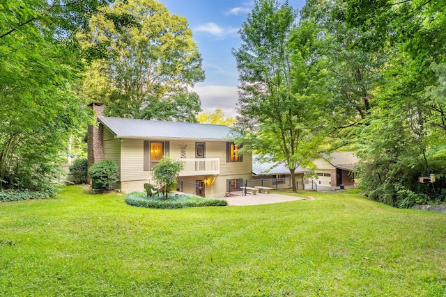1920 Campbell Dr NW, Cleveland, TN 37312 - back of property featuring a chimney, a yard, and a metal roof