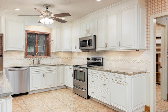 1920 Campbell Dr NW, Cleveland, TN 37312 - kitchen with stainless steel appliances, light stone counters, white cabinets, a ceiling fan, and tasteful backsplash