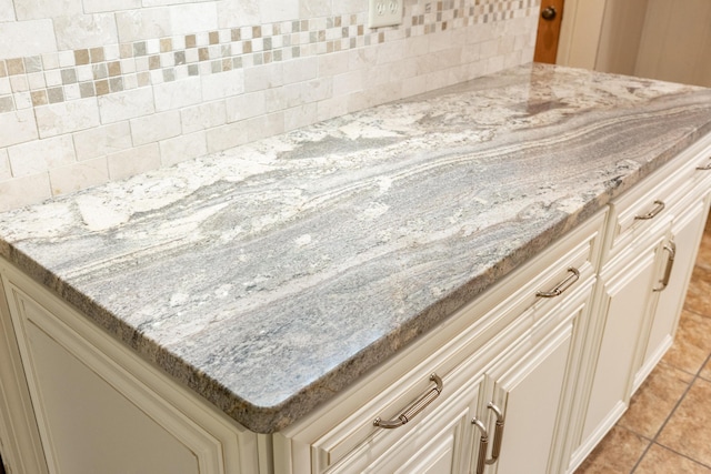 1920 Campbell Dr NW, Cleveland, TN 37312 - kitchen view of light stone counters, cream cabinets, and tasteful backsplash