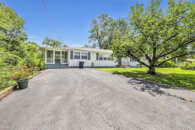 5506 Sunny Dell Ln, Chattanooga, TN 37412 - view of front of property with a sunroom, a front yard, and asphalt driveway